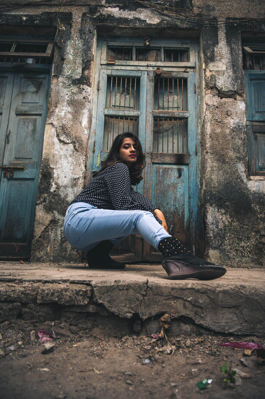 Gril posing in front of house door